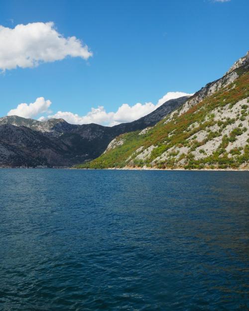 Beautiful landscape of the Bay of Kotor with mountains and blue skies in Montenegro.