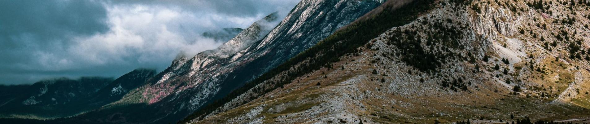 Scenic mountain landscape with clouds in Bosnia and Herzegovina, showcasing nature's beauty.