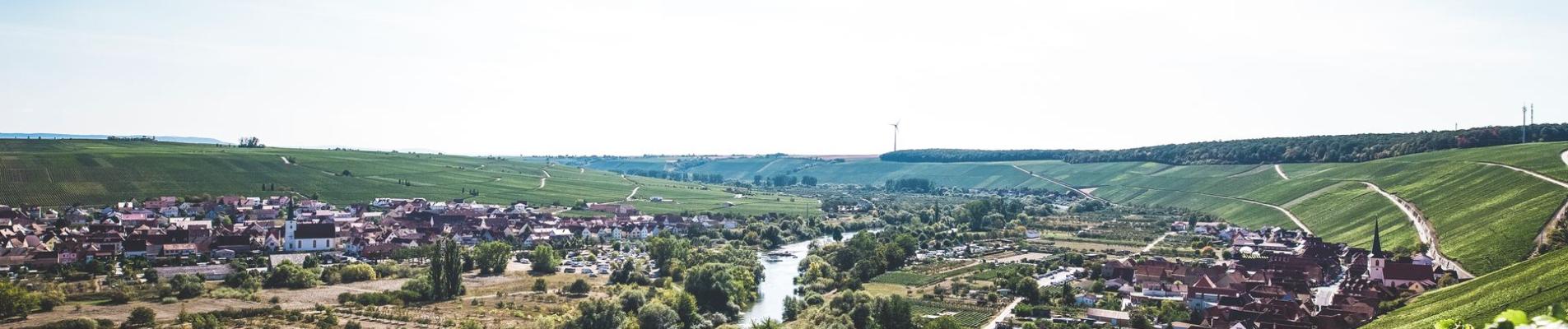 Scenic aerial view of Bavarian countryside with river and village in summer.