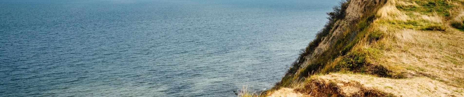 Breathtaking view of coastal cliffs on Insel Hiddensee overlooking the Baltic Sea under a clear sky.