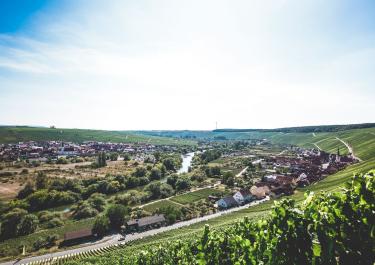 Scenic aerial view of Bavarian countryside with river and village in summer.
